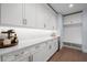 Pantry area with white cabinets, light countertops, beverage cooler and mud room at 419 S Shore Crest Dr, Tampa, FL 33609