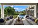 Relaxing outdoor patio with comfortable seating overlooking a sparkling pool and manicured lawn at 419 S Shore Crest Dr, Tampa, FL 33609