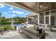 Luxurious patio with comfortable seating, an outdoor kitchen, and views of the pool and waterfront at 419 S Shore Crest Dr, Tampa, FL 33609