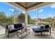 Screened-in patio features comfortable furniture, a view of the pool, and a lush backyard at 419 S Shore Crest Dr, Tampa, FL 33609