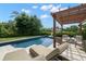 Backyard features a gorgeous pool with chaise lounges, a covered pergola and a firepit at 419 S Shore Crest Dr, Tampa, FL 33609