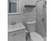Clean bathroom with updated fixtures, marble tile shower and flooring, and floating shelf at 4238 Glissade Dr, New Port Richey, FL 34652