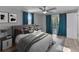Bright staged bedroom with large bed, ceiling fan, and sliding glass door to backyard at 4238 Glissade Dr, New Port Richey, FL 34652