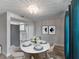 Cozy dining area with a round marble table and views of the kitchen and modern artwork at 4238 Glissade Dr, New Port Richey, FL 34652