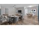 Open-concept living and dining area with modern furnishings, natural lighting, and a ceiling fan at 4238 Glissade Dr, New Port Richey, FL 34652