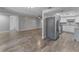 Open living space showcasing wood floors, kitchen appliances, and ample natural light at 4238 Glissade Dr, New Port Richey, FL 34652
