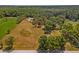 Expansive land plot featuring a mix of cleared fields and dense woodlands, perfect for development or a private estate at 495 Appaloosa Rd, Tarpon Springs, FL 34688