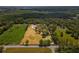Aerial view of a spacious property with defined lot lines surrounded by lush greenery and trees at 495 Appaloosa Rd, Tarpon Springs, FL 34688