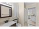 Bathroom with a vanity, cabinet and shower with view to the kitchen at 495 Appaloosa Rd, Tarpon Springs, FL 34688