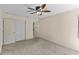 Bedroom featuring carpet, ceiling fan and ensuite bathroom and closet at 495 Appaloosa Rd, Tarpon Springs, FL 34688