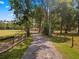 Long, private driveway winding through mature trees, leading to your secluded retreat at 495 Appaloosa Rd, Tarpon Springs, FL 34688