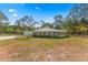 Unique home featuring lush landscaping, circular design, and detached garage with plenty of space at 495 Appaloosa Rd, Tarpon Springs, FL 34688