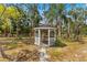 Charming gazebo nestled among mature trees, offering a peaceful outdoor retreat at 495 Appaloosa Rd, Tarpon Springs, FL 34688