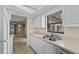 Bright kitchen with stainless steel appliances, ample counter space, and a view of the living room at 495 Appaloosa Rd, Tarpon Springs, FL 34688