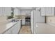 Well-lit kitchen with stainless steel appliances, white cabinets, and a window offering outside views at 495 Appaloosa Rd, Tarpon Springs, FL 34688