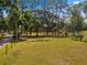 Sprawling lot with mature trees and partially fenced perimeter, offering privacy at 495 Appaloosa Rd, Tarpon Springs, FL 34688