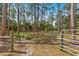 Wooded lot with mature trees and a metal gate, ready for your dream home or investment at 495 Appaloosa Rd, Tarpon Springs, FL 34688