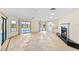 Spacious living room with tile floors, fireplace, and access to the screened-in lanai offering seamless indoor-outdoor living at 495 Appaloosa Rd, Tarpon Springs, FL 34688