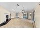 Bright living room featuring a fireplace, tile floors, large sliding doors and statement chandelier at 495 Appaloosa Rd, Tarpon Springs, FL 34688