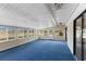 Spacious sunroom with an abundance of windows and a blue carpet at 495 Appaloosa Rd, Tarpon Springs, FL 34688