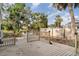 Wooden deck with a seating area, wooden railing, and backyard view surrounded by trees at 504 Casas Bonitas Dr, Nokomis, FL 34275