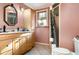 Bathroom featuring a toilet, shower, mirror and single sink vanity with ample storage space at 504 Casas Bonitas Dr, Nokomis, FL 34275