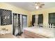 Cozy bedroom featuring a ceiling fan, ample natural light and a decorative picket fence headboard at 504 Casas Bonitas Dr, Nokomis, FL 34275