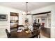 Dining room with dark wood table, chandelier, and views of other rooms at 504 Casas Bonitas Dr, Nokomis, FL 34275