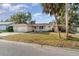 Inviting single-Gathering home with a well-maintained lawn, mature trees, and an attached garage at 504 Casas Bonitas Dr, Nokomis, FL 34275