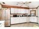 Bright kitchen with white cabinets and tile flooring, offers ample storage and countertop space at 504 Casas Bonitas Dr, Nokomis, FL 34275