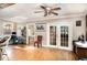 Sunlit living room with wood floors, french doors and multiple entry points for a smooth transition between rooms at 504 Casas Bonitas Dr, Nokomis, FL 34275