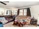 Bright living room with tile floors, two sofas, and a mirror wall at 504 Casas Bonitas Dr, Nokomis, FL 34275