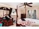 Bedroom features a four-poster bed, natural light, and a calming, comfortable ambiance at 504 Casas Bonitas Dr, Nokomis, FL 34275