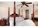Spacious bedroom with a four-poster bed, ceiling fan, and ample natural light at 504 Casas Bonitas Dr, Nokomis, FL 34275