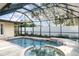 Enclosed pool featuring a built in spa, covered enclosure, and ample space for entertaining at 504 Casas Bonitas Dr, Nokomis, FL 34275