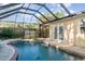 Enclosed in-ground pool with an attached spa and nearby patio doors for easy access at 504 Casas Bonitas Dr, Nokomis, FL 34275