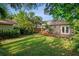 A spacious backyard with a wooden deck and mature trees, providing a private outdoor retreat at 5707 N Branch Ave, Tampa, FL 33604