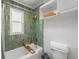 Stylish bathroom boasts a tiled tub surround with a window and built in shelves at 5707 N Branch Ave, Tampa, FL 33604