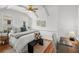 Cozy bedroom features a ceiling fan, multiple windows, and hardwood floors at 5707 N Branch Ave, Tampa, FL 33604
