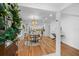 Bright dining room with hardwood floors, modern chandelier, and open access to the kitchen at 5707 N Branch Ave, Tampa, FL 33604