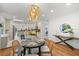 Elegant dining area featuring a stylish chandelier and a glimpse of the modern kitchen at 5707 N Branch Ave, Tampa, FL 33604
