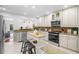 Modern kitchen featuring granite countertops, stainless steel appliances, and a functional kitchen island at 5707 N Branch Ave, Tampa, FL 33604