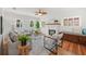 Cozy living room featuring hardwood floors, a decorative fireplace, and an abundance of natural light at 5707 N Branch Ave, Tampa, FL 33604