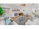 Bright living space boasting hardwood floors, a charming fireplace, and a ceiling fan at 5707 N Branch Ave, Tampa, FL 33604
