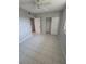 A tidy bedroom with tiled floors, neutral walls, closet space, and a ceiling fan at 6315 Shoreline Dr # 3107, St Petersburg, FL 33708