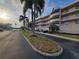 Inviting exterior view showcasing the well-maintained building, palm trees and landscaping at 6315 Shoreline Dr # 3107, St Petersburg, FL 33708