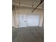 Exterior of a one-car garage featuring a door with slats and a separate entrance at 6315 Shoreline Dr # 3107, St Petersburg, FL 33708
