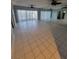 Spacious living room with tile flooring, ceiling fan, and view to balcony at 6315 Shoreline Dr # 3107, St Petersburg, FL 33708