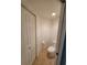 A compact half-bath features a toilet and a door for added privacy within the home at 6315 Shoreline Dr # 3107, St Petersburg, FL 33708