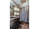 Bathroom with unique fixtures and a modern shower curtain at 6421 Wilshire Dr, Tampa, FL 33615